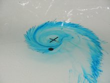 Effect of the Coriolis force on the drainage of a circular tank